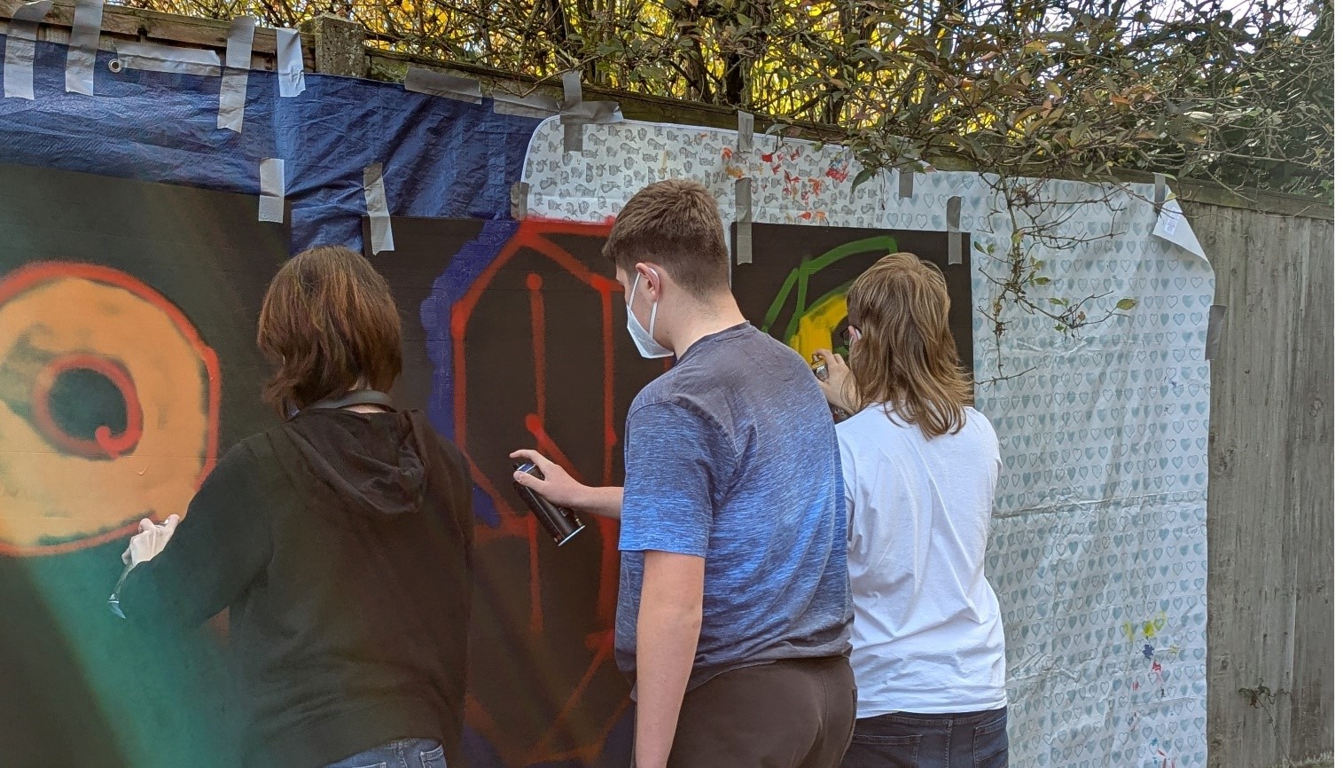 Young people creating street art